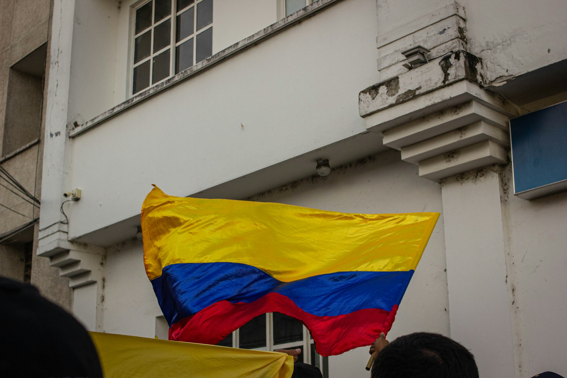a man holding a flag in front of a building
